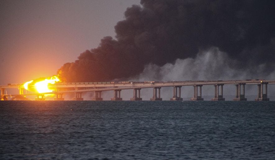 Flame and smoke rise fron Crimean Bridge connecting Russian mainland and Crimean peninsula over the Kerch Strait, in Kerch, Crimea, Saturday, Oct. 8, 2022. Russian authorities say a truck bomb has caused a fire and the partial collapse of a bridge linking Russia-annexed Crimea with Russia. Three people have been killed. The bridge is a key supply artery for Moscow&#39;s faltering war effort in southern Ukraine. (AP Photo)