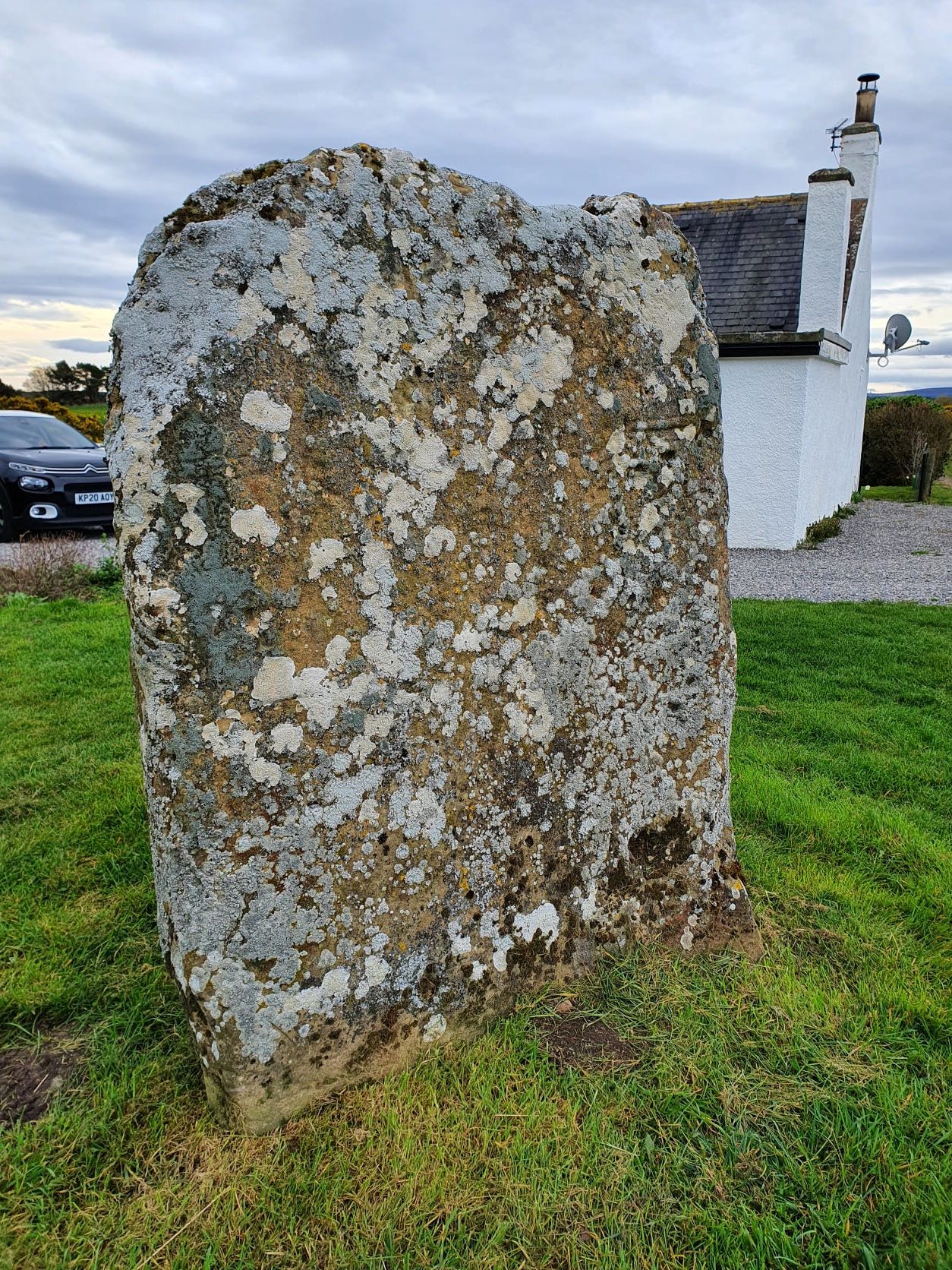 The cross-face of the Kebbuck Stone, eroded and overgrown with lichen