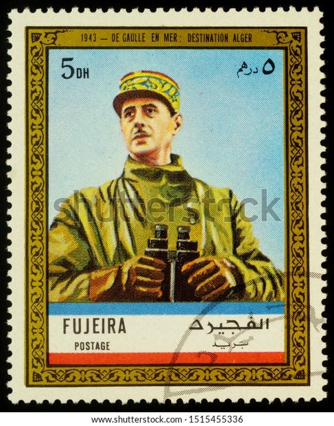 Moscow, Russia - September 26, 2019: A stamp printed in Fujeira shows General de Gaulle in uniform with binoculars at sea in 1943: destination Algiers, series "Charles de Gaulle", circa 1972