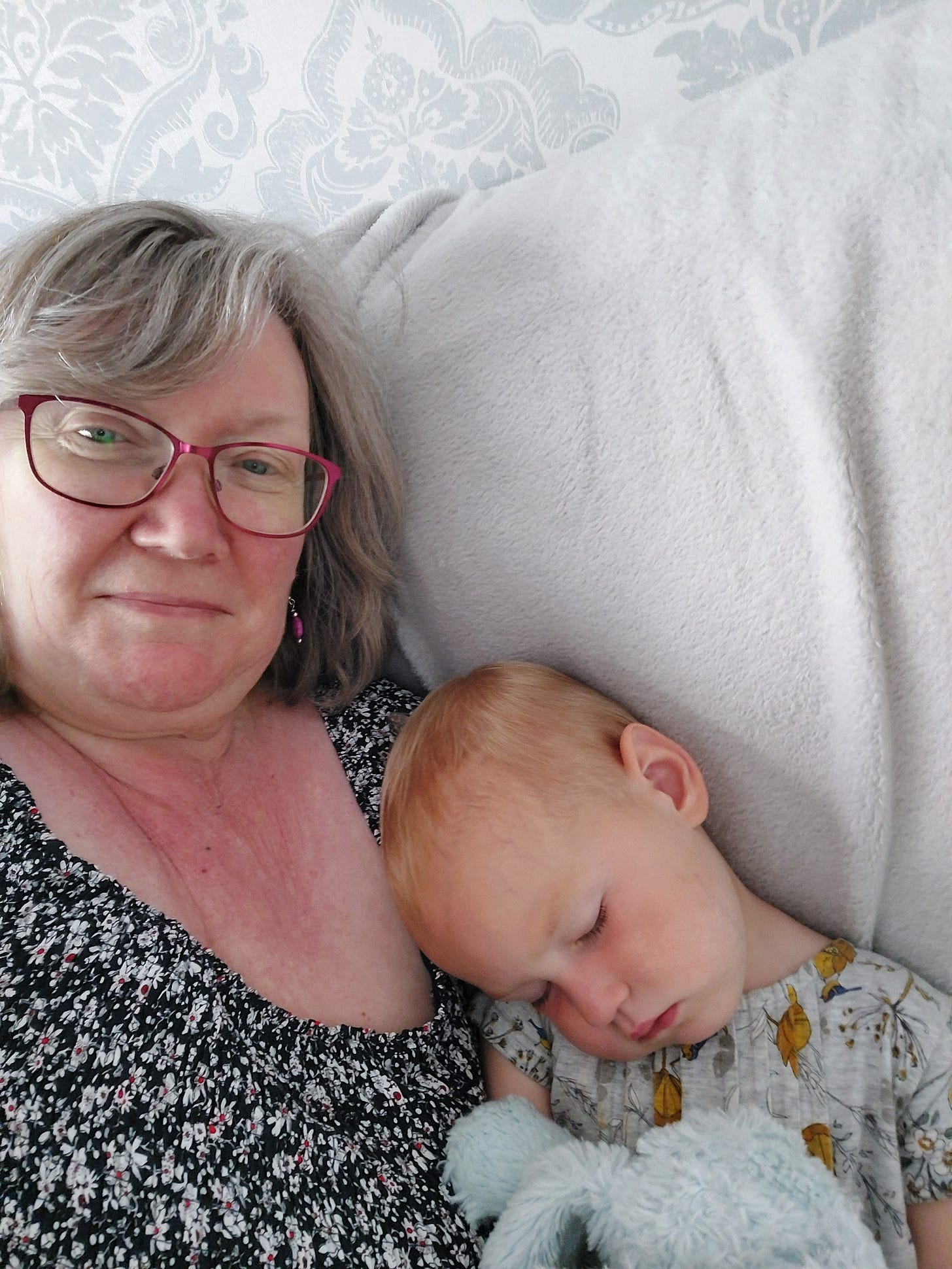toddler asleep on a safe, cuddling up to her grandmother