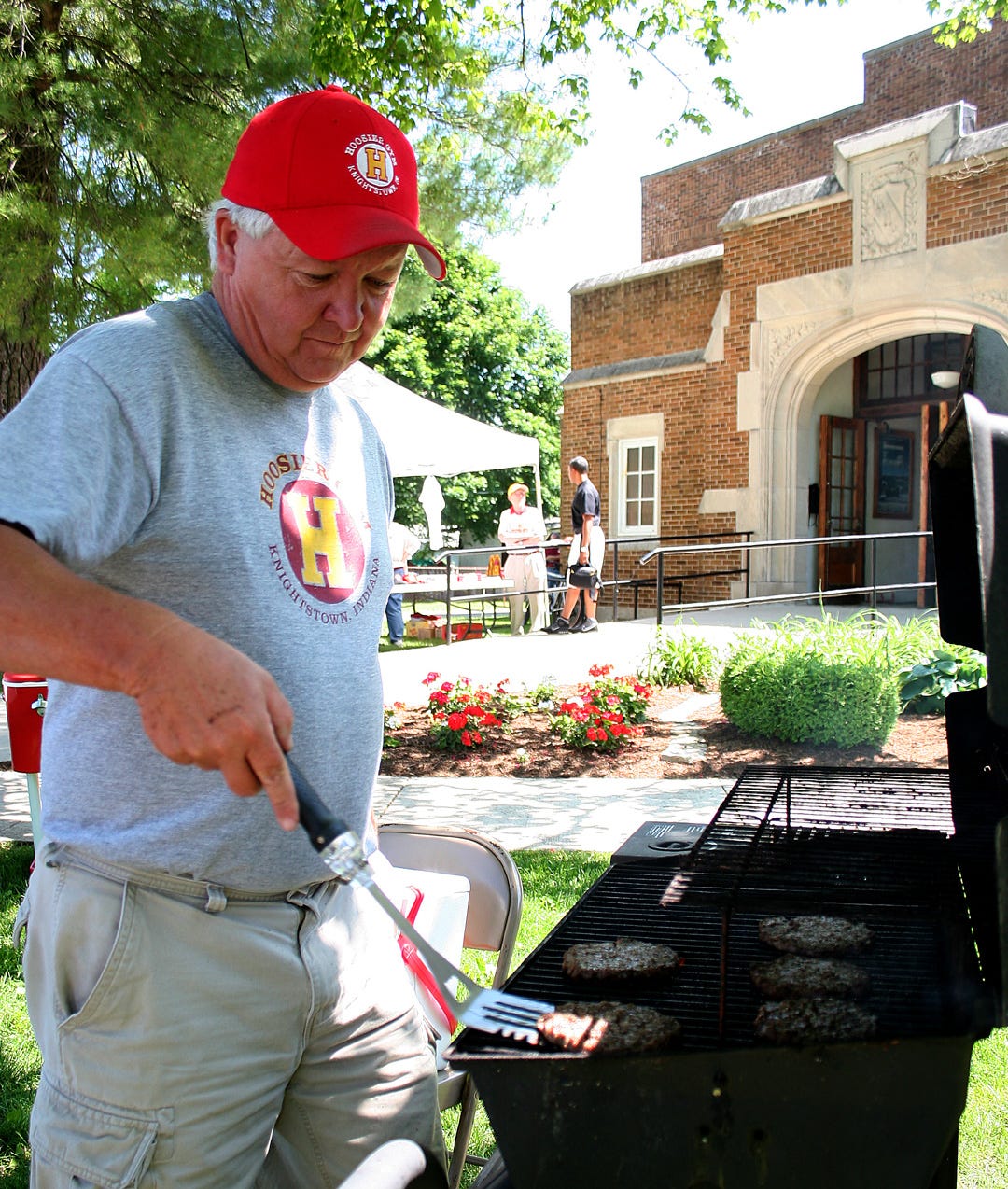 Grilling hamburgers for the concession stand in 2009, longtime Hoosier Gym volunteer Larry Loveall is no stranger to gym events. Concession stand sales bolster the gym’s limited finances. That means Loveall and other gym volunteers regularly busy themselves preparing and selling hot dogs, popcorn and other items to hungry visitors.