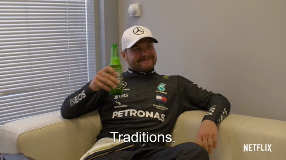 Bottas holding a beer, saying "Traditions."