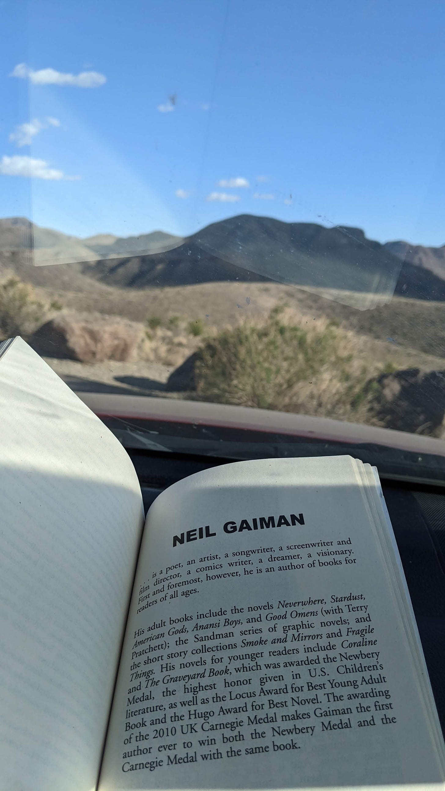 Book with Neil Gaimon's blurb, next to a landscape