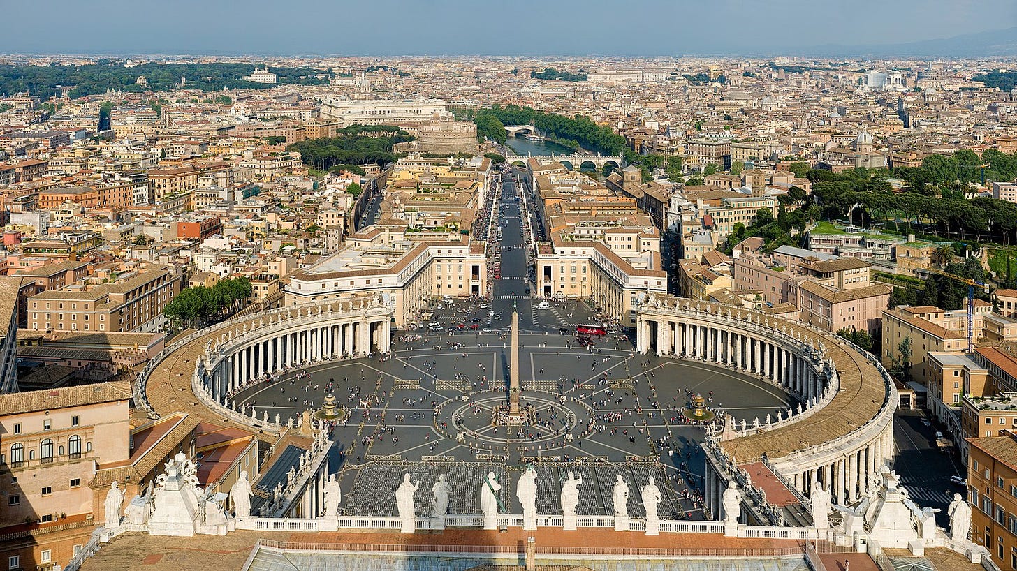 A view of St. Peter's Square in Vatican City from the top of the Basilica. Rome is visible in the background.. 