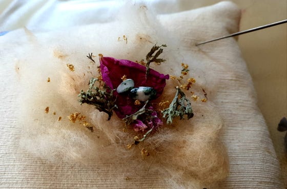 A medicine bundle in the form of herbs and crystals on wool 