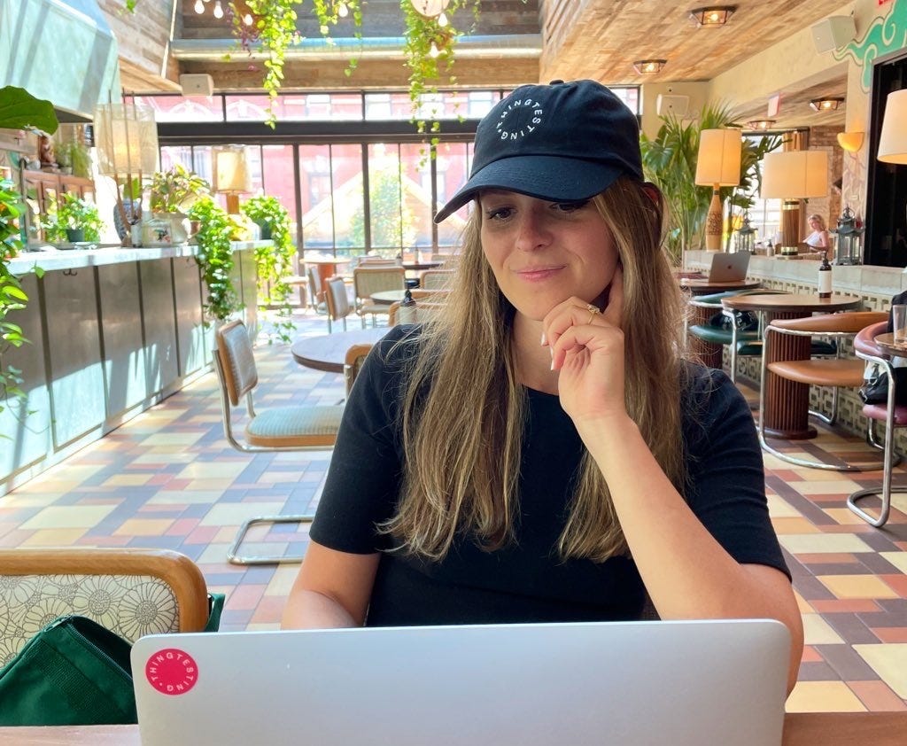 Photo of Natalie Sportelli, head of content at Thingtesting, working on her computer in a cafe.
