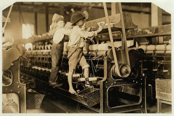 Children working machines in a mill during the Industrial Revolution. (Lewis Hine / Public domain)