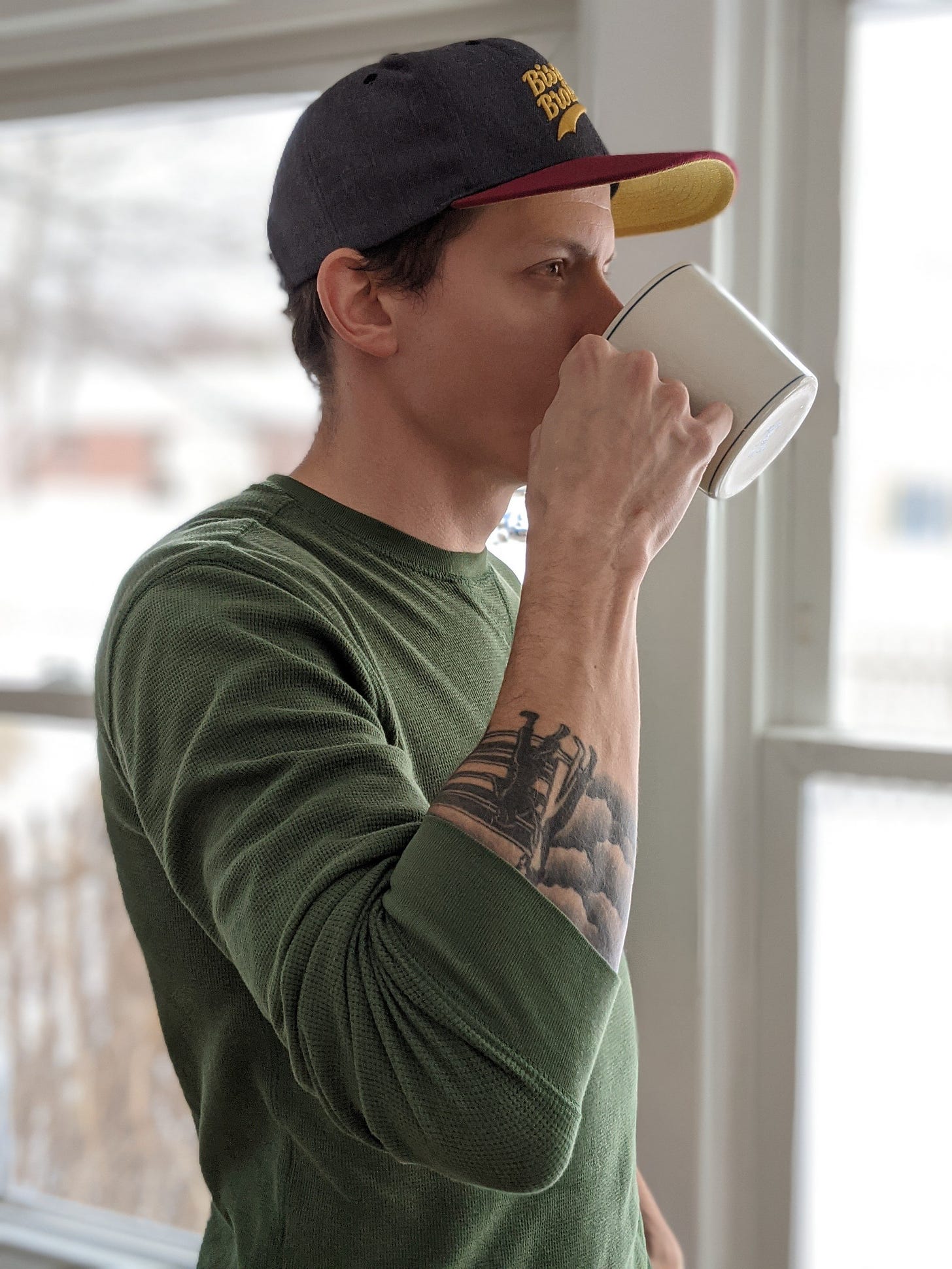 newsletter author drinking coffee, looking out window