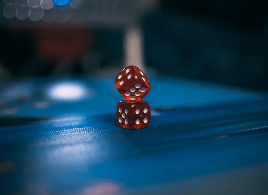Orange and White Dices on Blue Surface