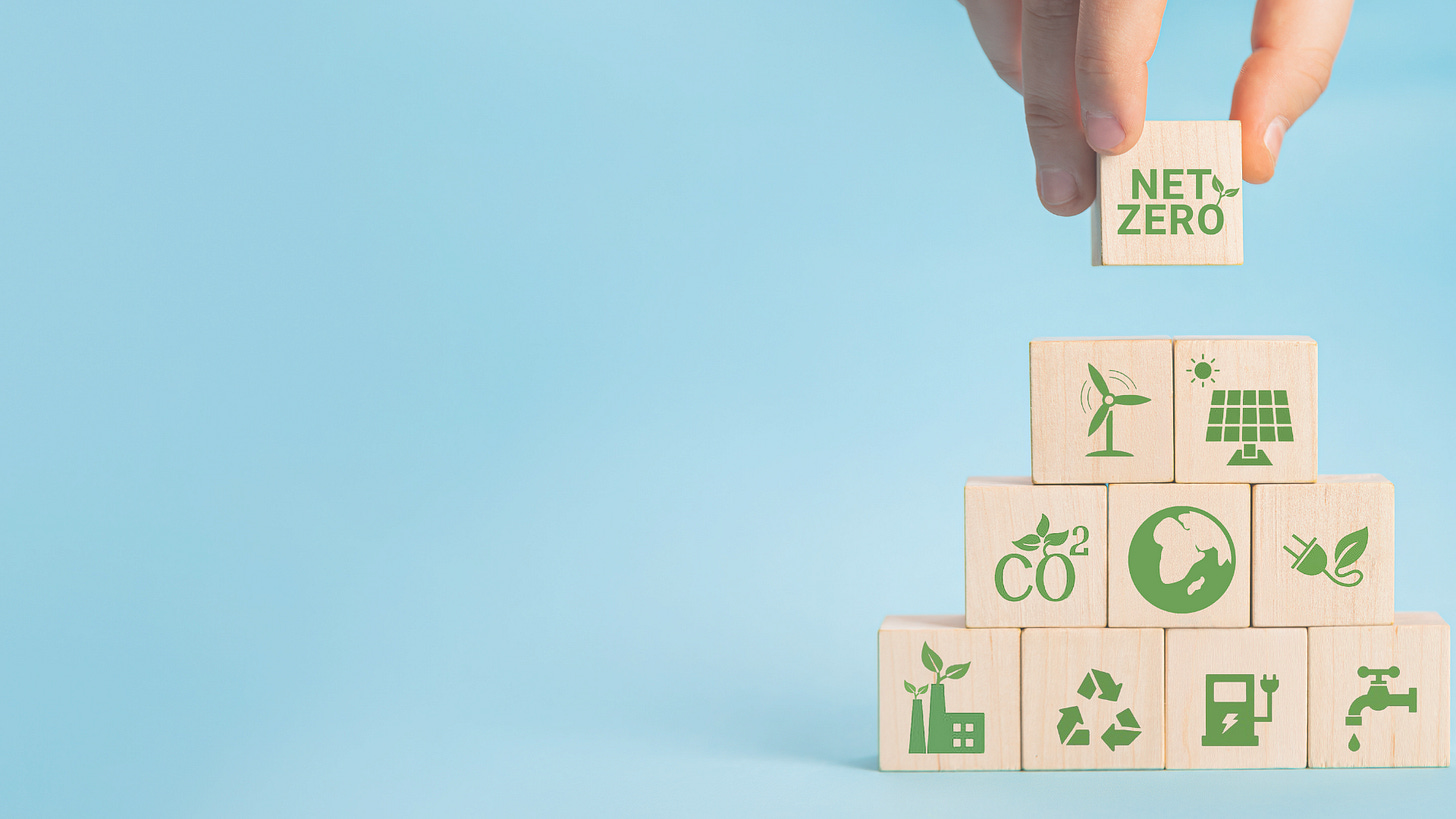 wooden cubes with earth-friendly icons being stacked