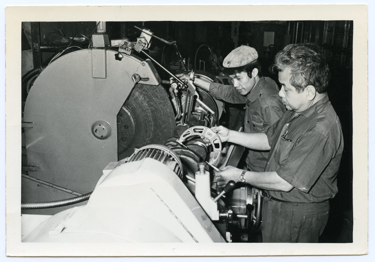 A black and white photo of my grandfather machining a part next to one of his employees