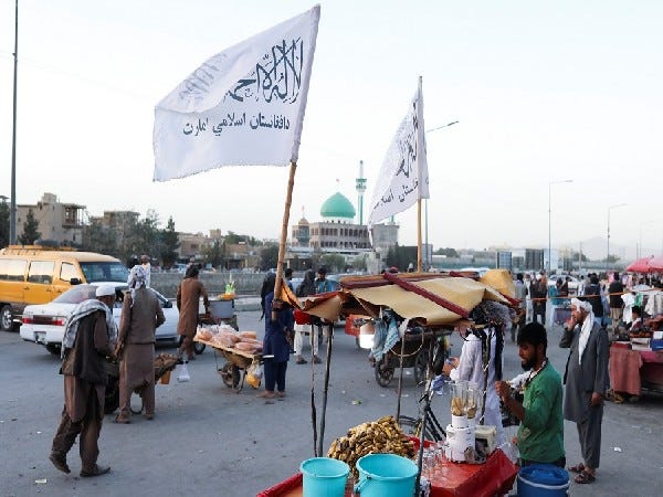 A group of people at an outdoor market

Description automatically generated with medium confidence