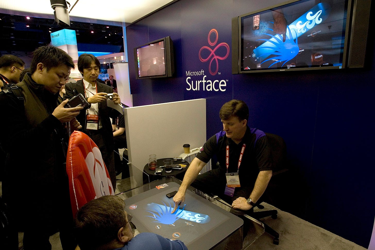 A Microsoft employee shows people the new Microsoft Surface at the 2008 International Consumer Electronics Show at the Las Vegas Convention Center January 9, 2008 in Las Vegas, Nevada. Surface is the Microsoft Vista-based platform that was formerly named "PlayTable." The first commercial implementations of Surface systems are expected to be deployed by hotels, casinos and cell-phone retailers in Spring 2008. CES, the world's largest annual consumer technology tradeshow, runs through tomorrow and features 2,700 exhibitors showing off their latest products and services to more than 140,000 attendees