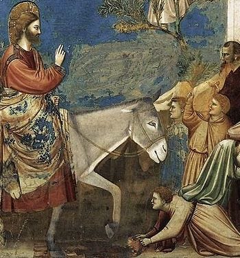 Detail from Giotto's famous fresco of Christ entering Jerusalem, centered on a slightly smiling donkey