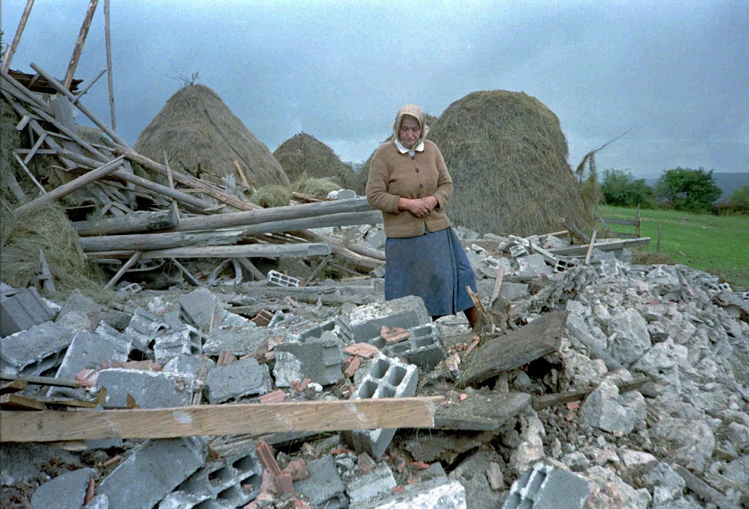 An unidentified Serb woman inspects debris of her home, destroyed in NATO air-strikes in the village of Vidrici, near Sokolac, some 50 kms northeast of Sarajevo Wednesday Aug 30 1995