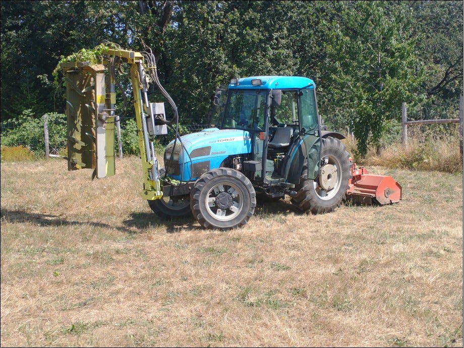 Tractor with hedger and mower.