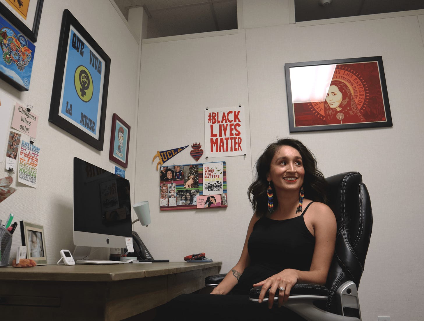 Education assistant professor Alma Flores pulls out a book from her library in her office at Sacramento State on Sept. 7, 2021.Flores said that on her first day of orientation she was one of four or two faculty Chicana out of 80 faculty. 