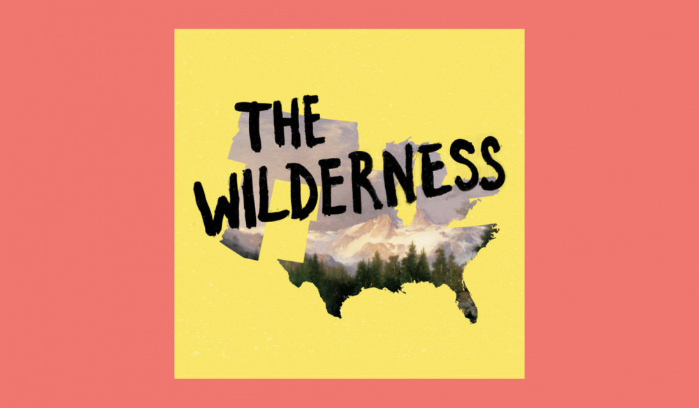 artwork van The Wilderness. je ziet de contouren van de kaart van de VS, met op de achtergrond een vergezicht van een bergachtig gebied. De titel staat er in het zwart overheen geschreven.