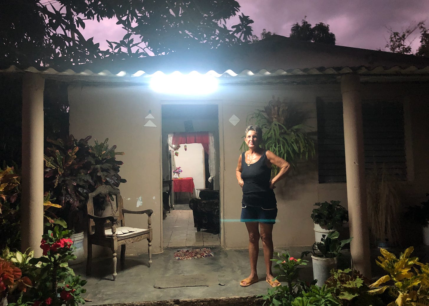 Woman standing on her porch in a singlet and shorts