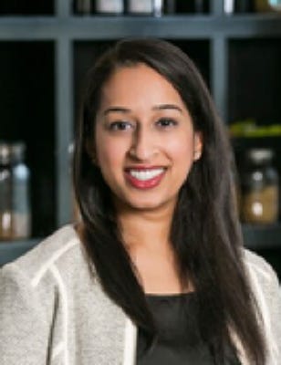 picture of a beautiful Indian American woman smiling brightly