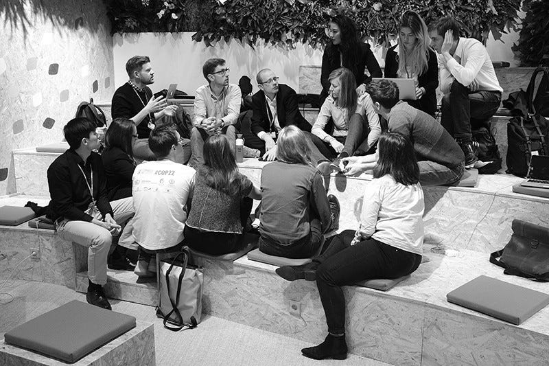 Participants huddle in a discussion at the COP 23 United Nations Climate Change Conference 2017 in Bonn, Germany