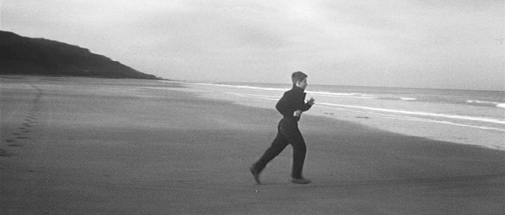 Still from The 400 Blows. Antoine runs on the beach.