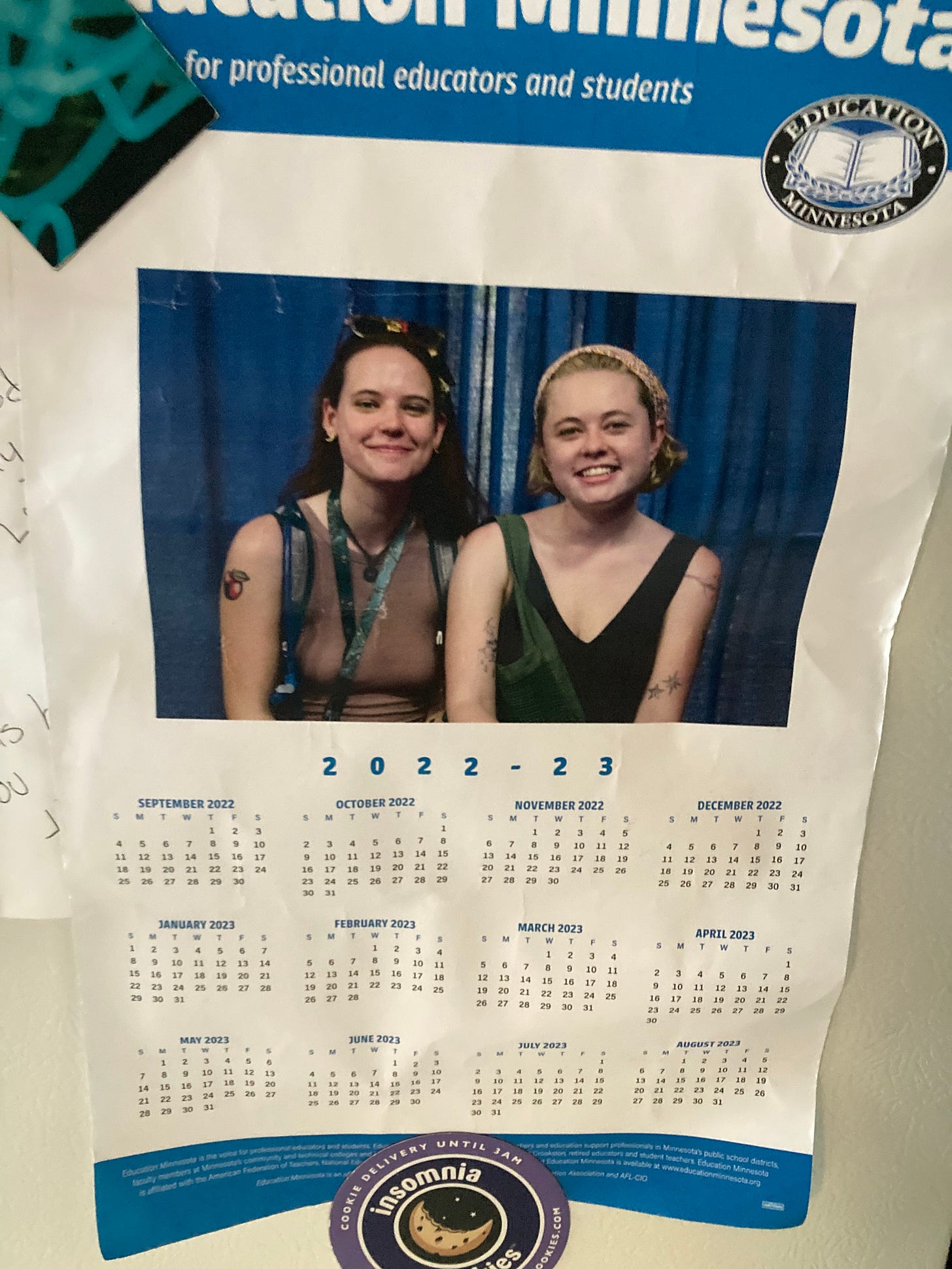 a photo of a yearly calendar with an image of two girls in tanktops smiling, the calendar has an Education Minnesota logo and reads "for professional educators and students"