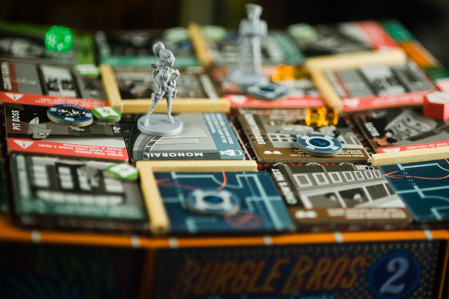 The board game Burgle Bros 2, with a miniature figure depicting one of the characters on a tile.