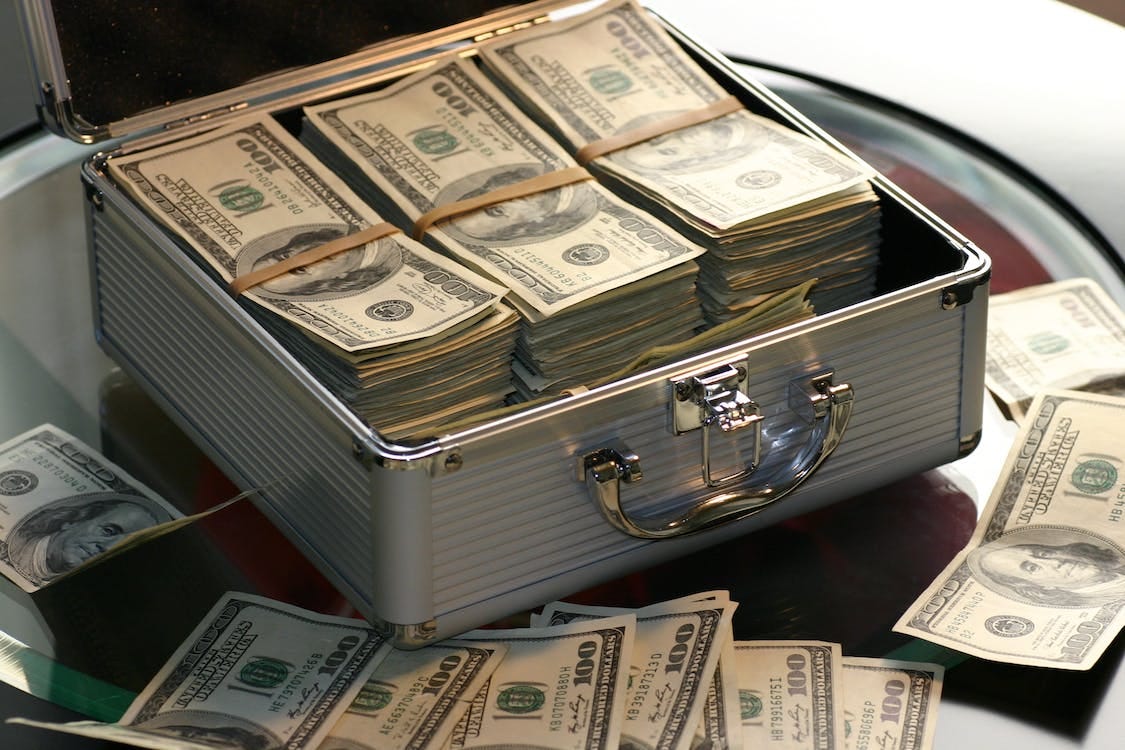 Free Hard Cash on a Briefcase Stock Photo