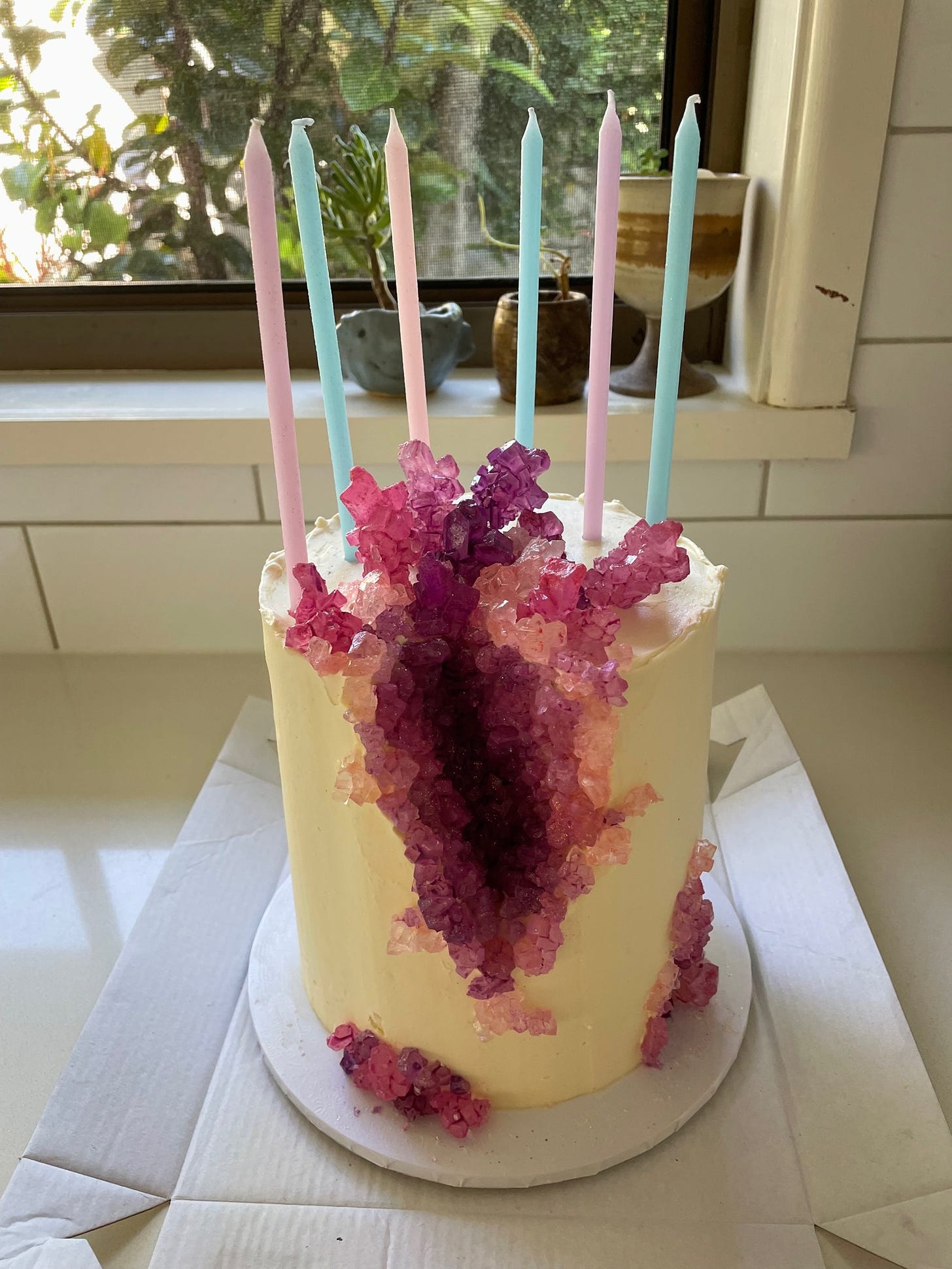 A photo of a geode cake, with purple sugar crystals inside.