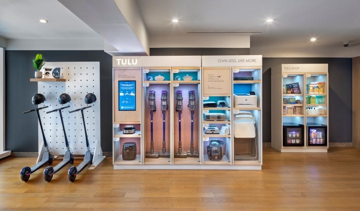 A rental cabinet filled with printers, scooters, and vacuum cleaners