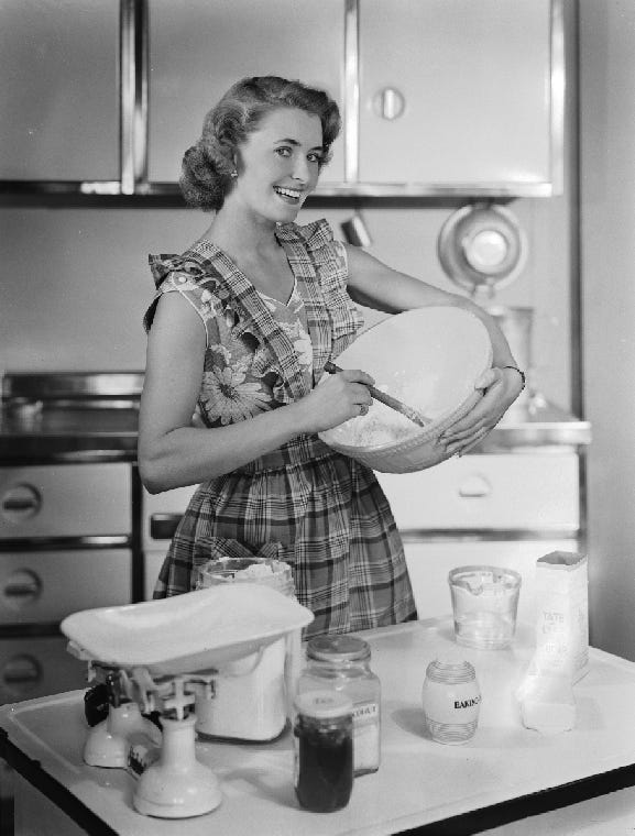 a woman mixes dough in a 1950s kitchen