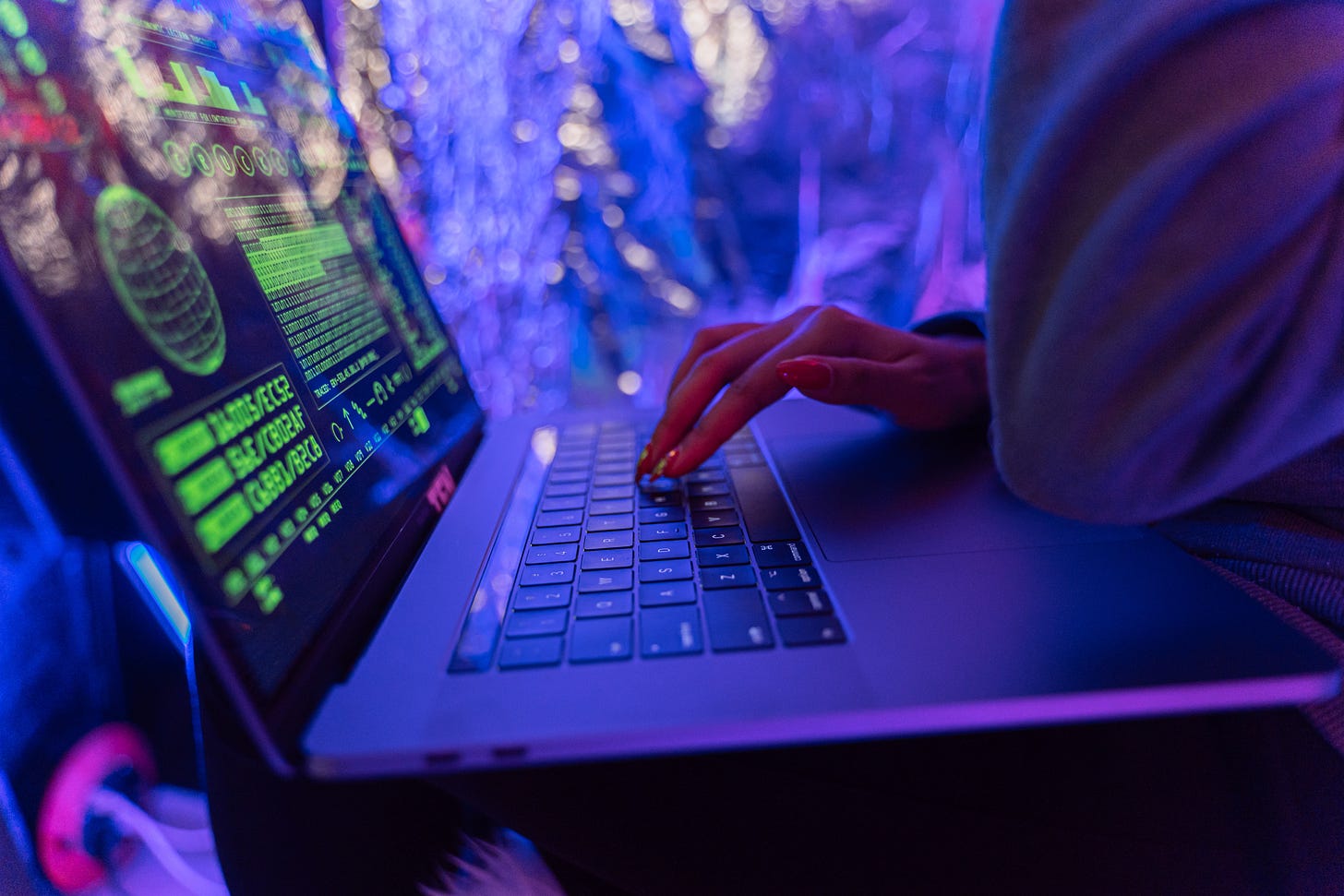 picture of a laptop with bokeh neon lighting in background