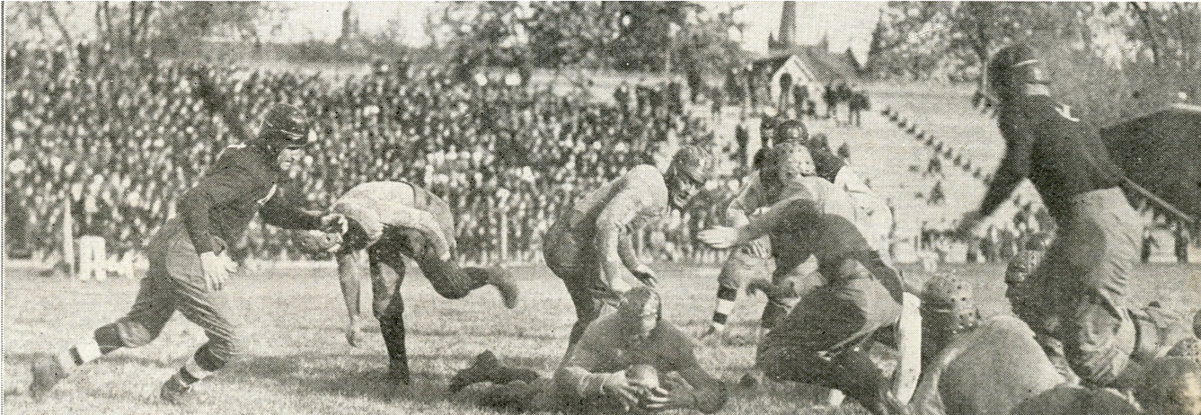Game action during the 1918 Great Lakes vs. Illinois contest. Great Lakes wears the dark jerseys.