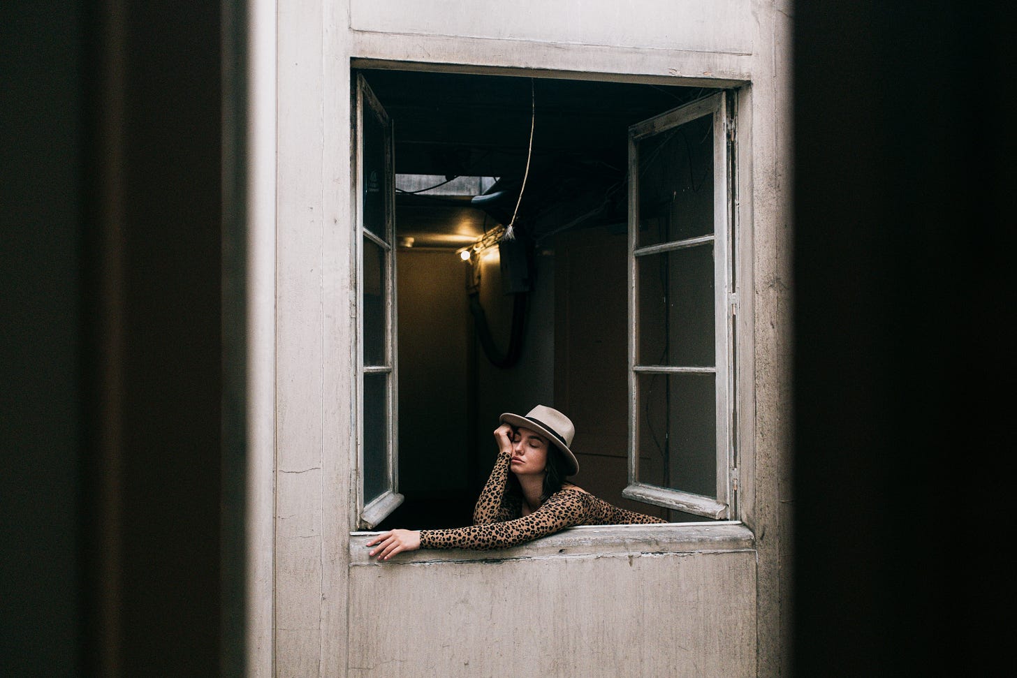 bored young woman in window