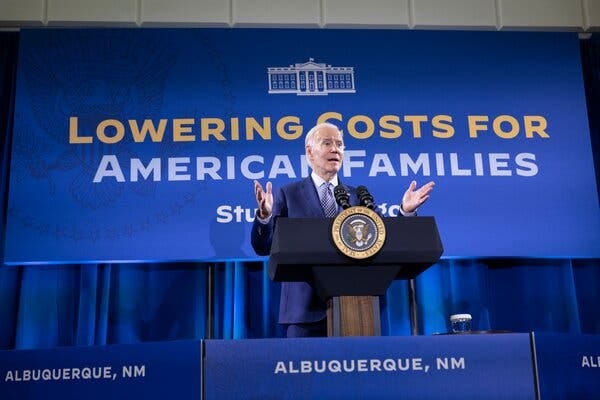 President Biden speaking at a podium behind a banner that reads “Lowering Costs for American Families.”