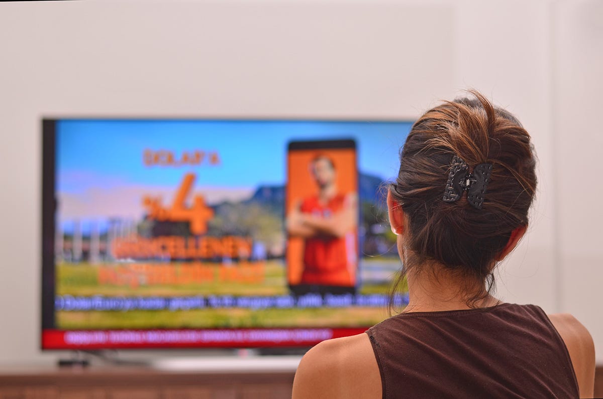 A person looking at a television

Description automatically generated with low confidence