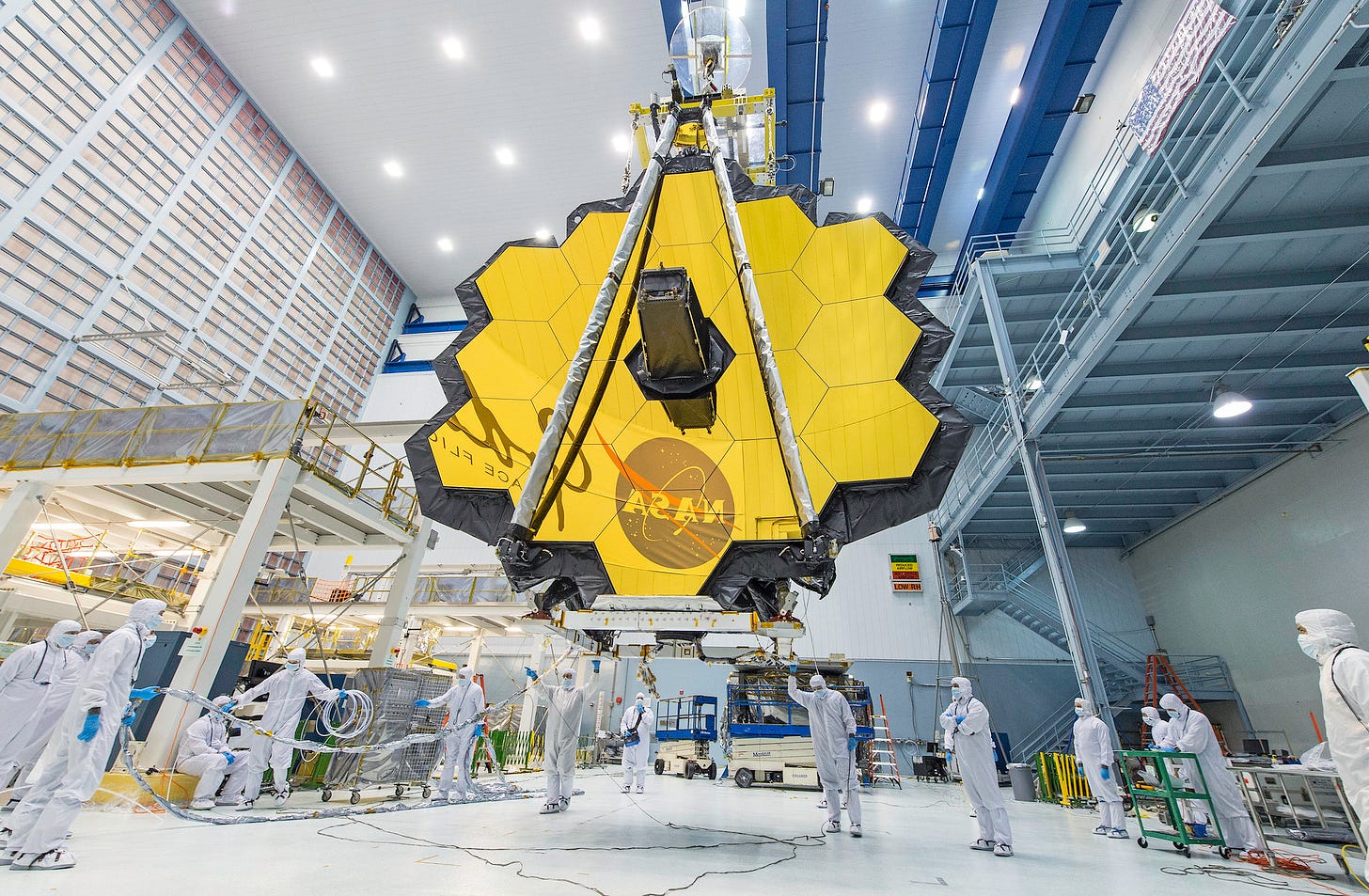 It's springtime and the deployed primary mirror of NASA's James Webb Space Telescope looks like a spring flower in full bloom.     In this photo, NASA technicians lifted the telescope using a crane and moved it inside a clean room at NASA’s Goddard Space Flight Center in Greenbelt, Maryland. Once launched into space, the Webb telescope’s 18-segmented gold mirror is specially designed to capture infrared light from the first galaxies that formed in the early Universe, and will help the telescope peer inside dust clouds where stars and planetary systems are forming today.