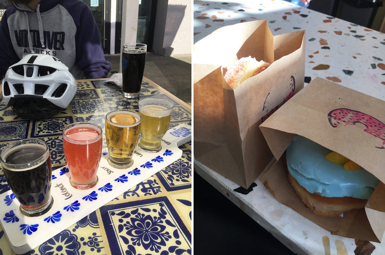 Left image: a flight of four beers, ranging from light to pink to dark, sit in a blue and white paddle on top of a table tiled in a similar pattern. Across the table is a bike helmet and a tall glass of dark beer. Right image: on a speckled countertop, two paper bags with a pink donut-shaped logo on the front. One on its side has a donut with blue icing, and the other is upright with a sugar-coated jelly donut just visible.