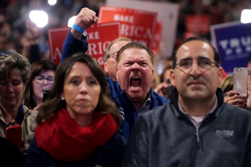 An angry dude yelling at a political rally