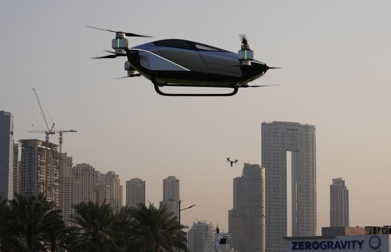 A XPeng X2, an electric flying taxi developed by the Guangzhou-based XPeng, Inc's aviation affiliate, is tested in front of the Marina District in Dubai, United Arab Emirates, Monday, Oct. 10, 2022. Monday’s demonstration was held with an empty cockpit, but the company says it carried out a manned flight test last year of the two-passenger vehicle. (AP Photo/Kamran Jebreili)