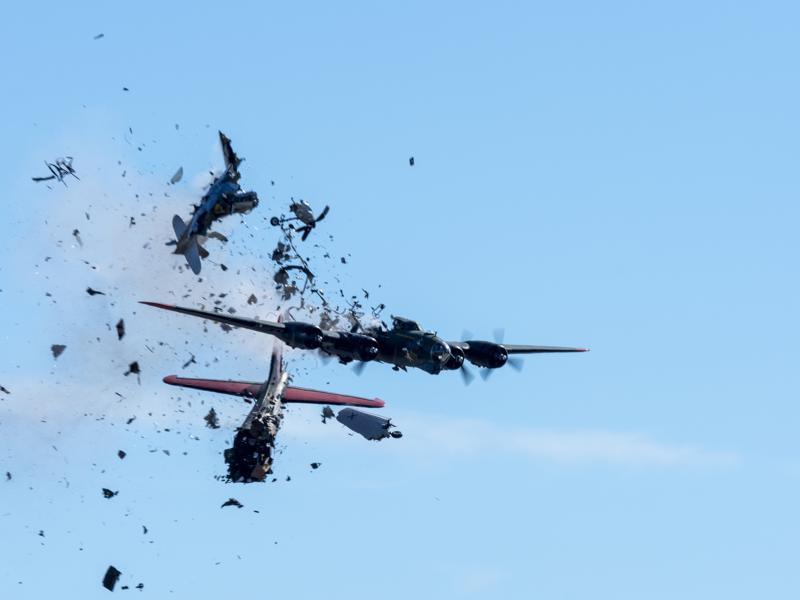 In this photo provided by Larry Petterborg, a Boeing B-17 Flying Fortress and a Bell P-63 Kingcobra collide in the midair during an airshow at Dallas Executive Airport in Dallas, Saturday, Nov. 12, 2022. (Larry Petterborg via AP)