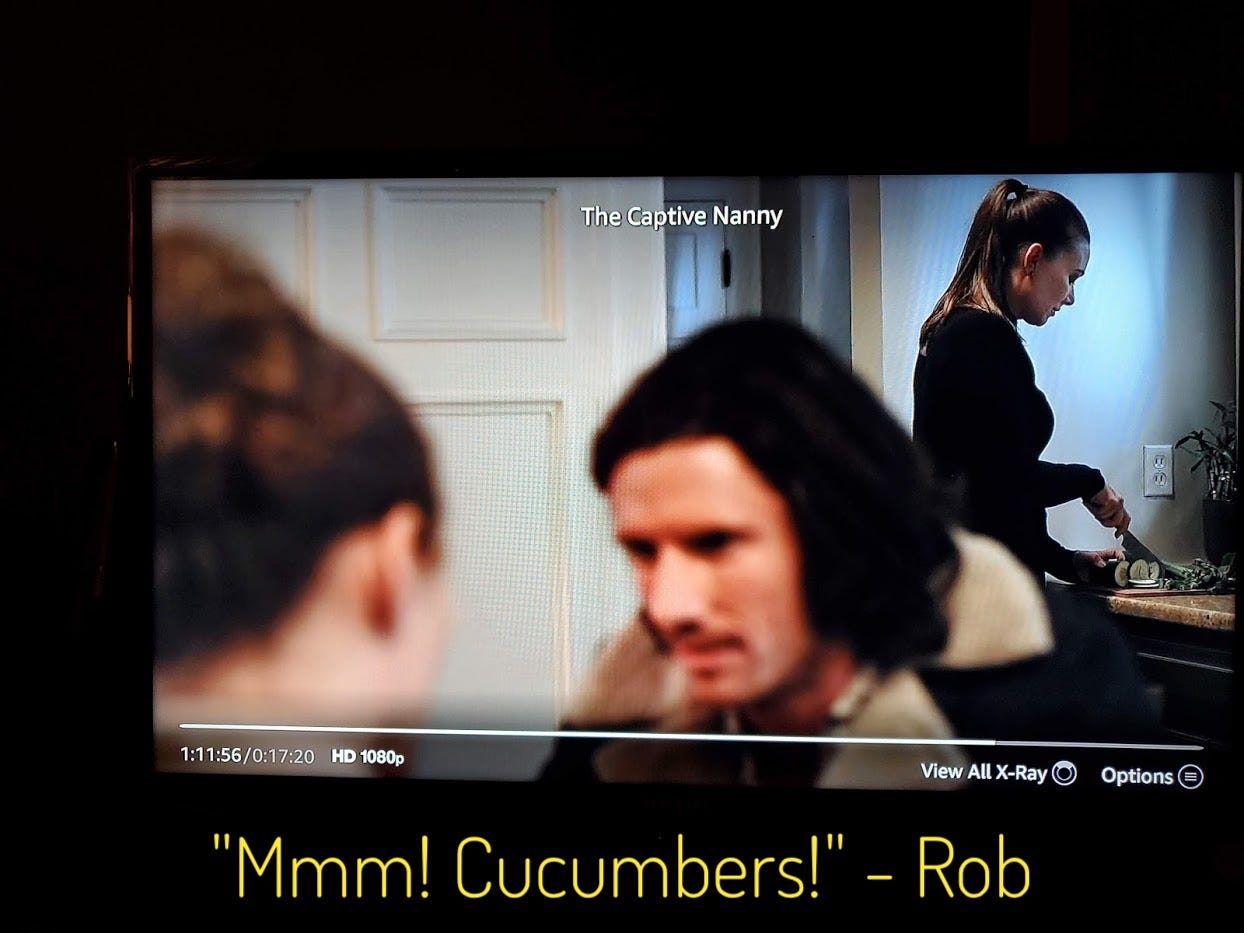 Emily slicing cucumbers in the background while Chloe and Rob talk in the foreground, captioned "Mmm! Cucumbers!" - Rob