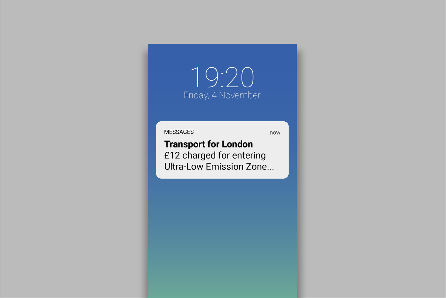 Text messaged on phone screen reading 'Transport for London. £12 charged for entering Ultra-Low Emission Zone'