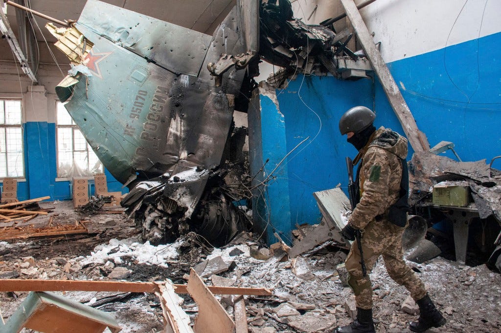 Ukrainian serviceman walks past the vertical tail fin of a Russian Su-34 bomber lying in a damaged building in Kharkiv, Ukraine.