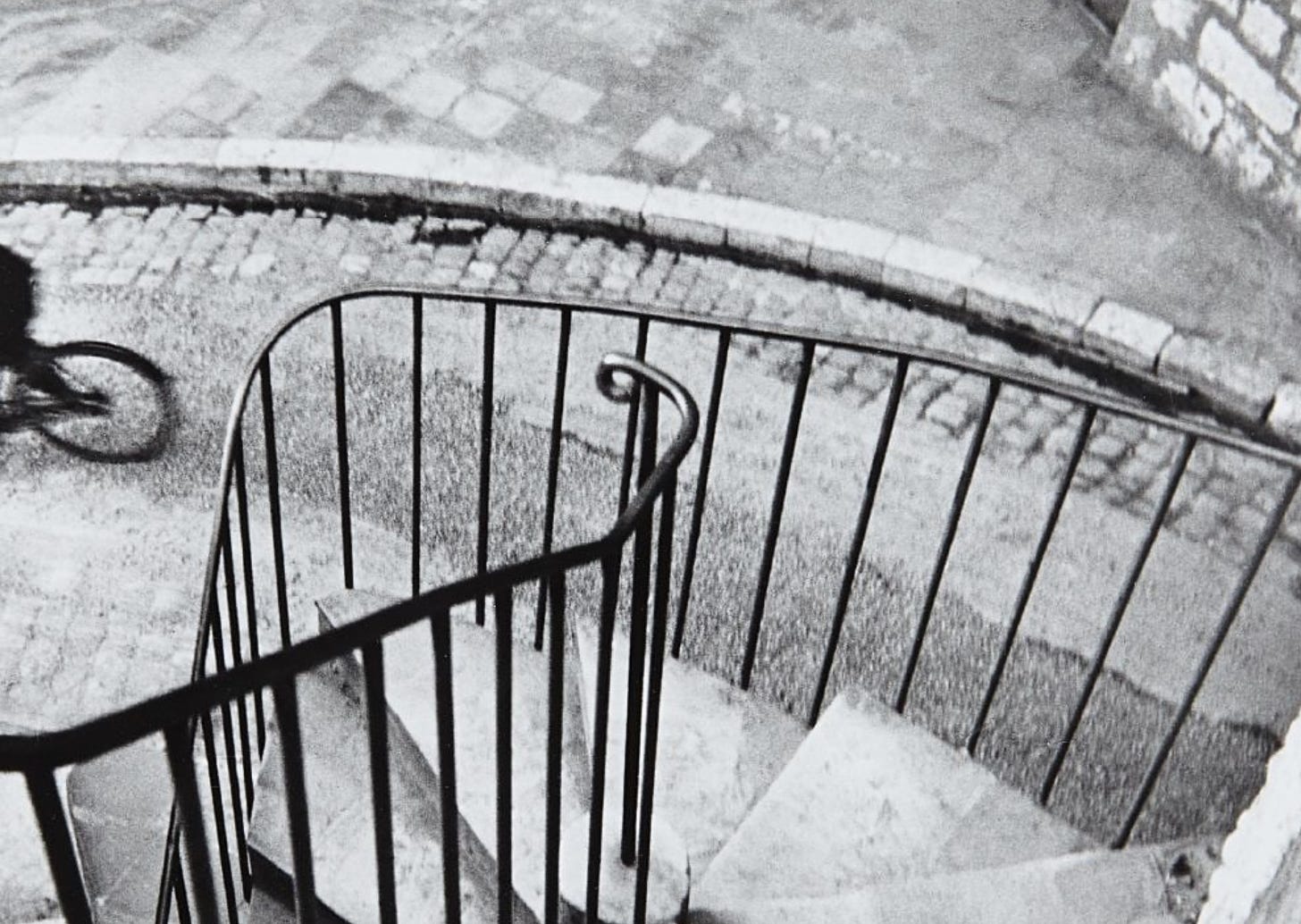 Zoomed in crop of the Hyères by Henri Cartier-Bresson focusing on the handrail with only the bicycles wheel visible on the far left of the frame