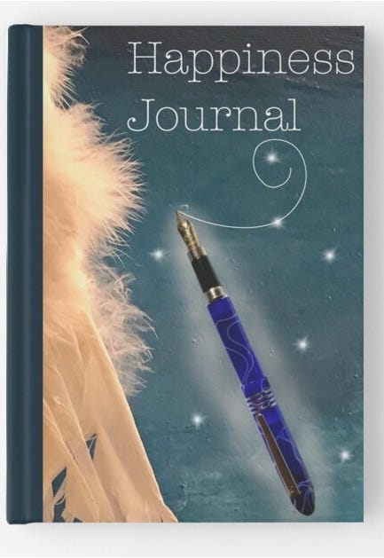 Happiness journal with an angel's wing and a blue fountain pen