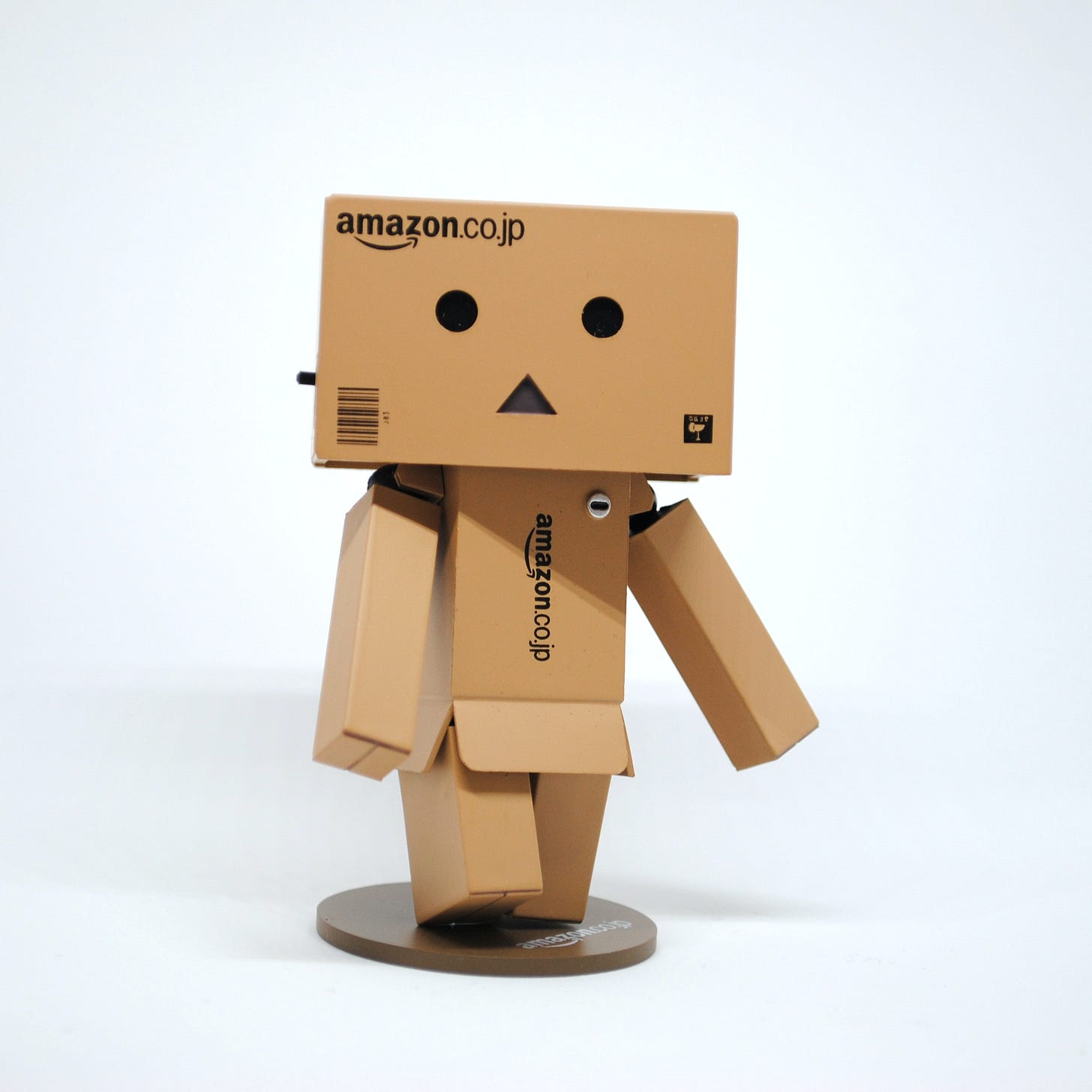 Photo of a man made out of Amazon-branded cardboard boxes. Unsplash