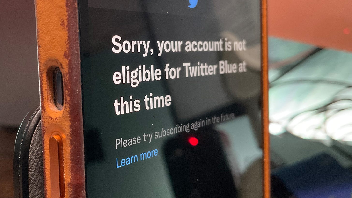 An iPhone displays the words, "Sorry, your account is not eligible for Twitter Blue at this time"