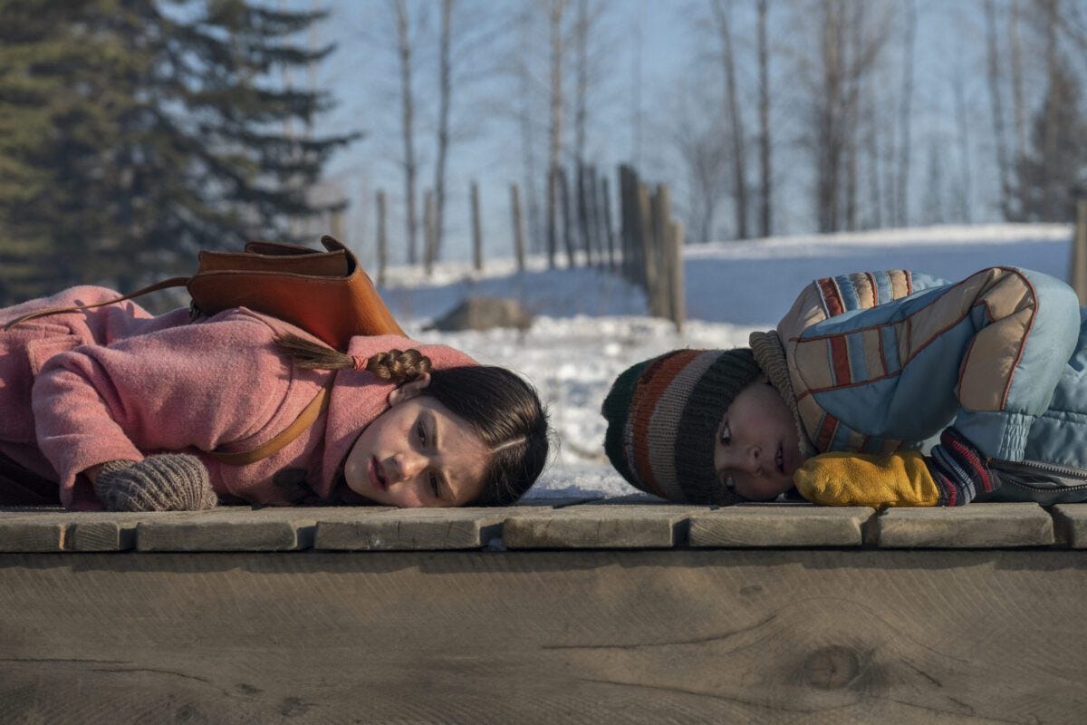 Two children listen to the sound of The Loop underground.